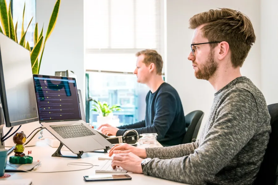 Friendly business owner working on laptop at a bright home office